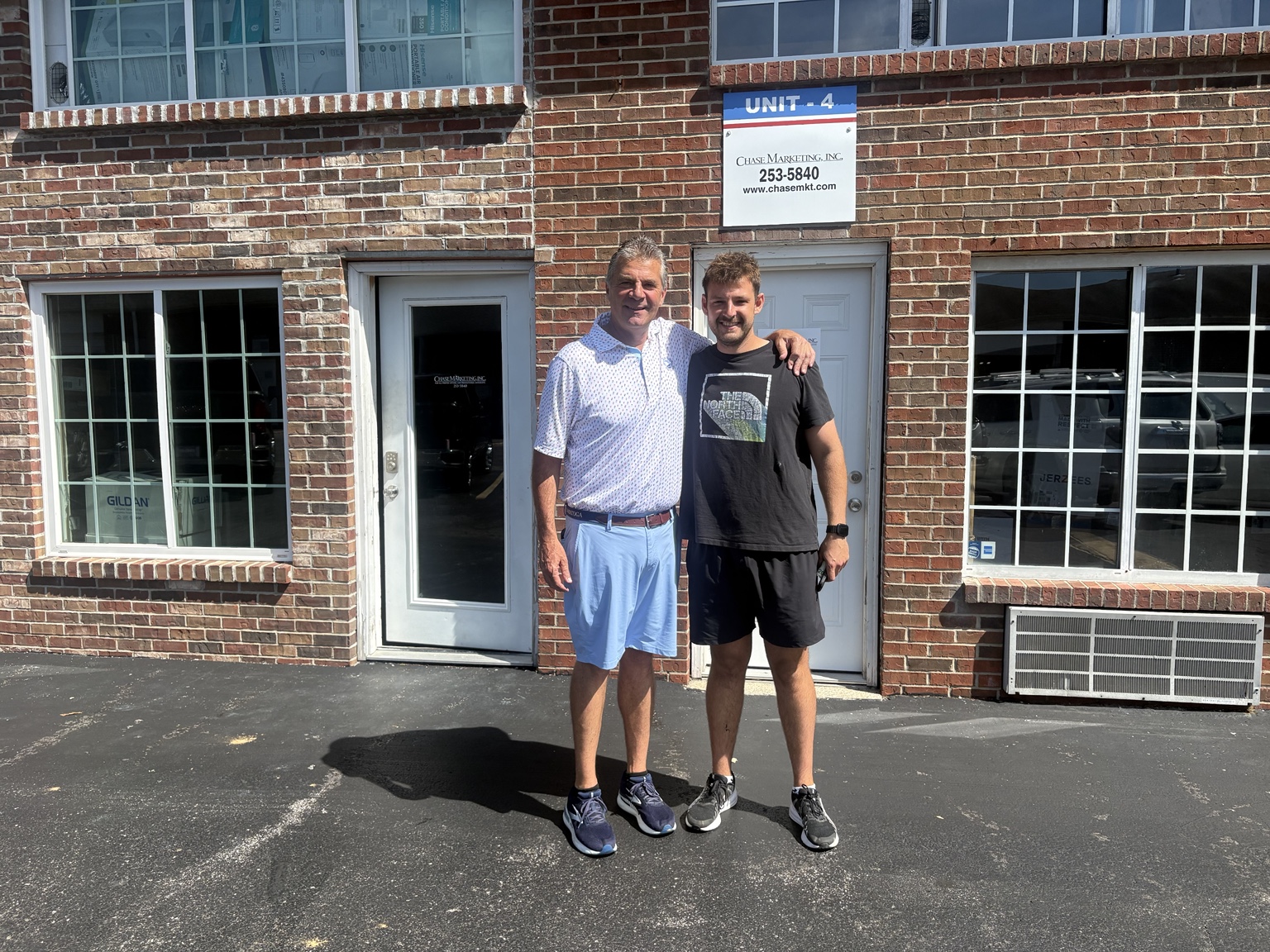 Tony and Chase Mitchell outside the Chase Marketing shop
